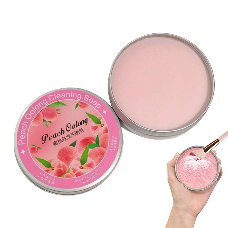 Makeup brush cleaning soap, peach scented soap with brush pad, powder puff, makeup brush, and beauty sponge cleaning function.
